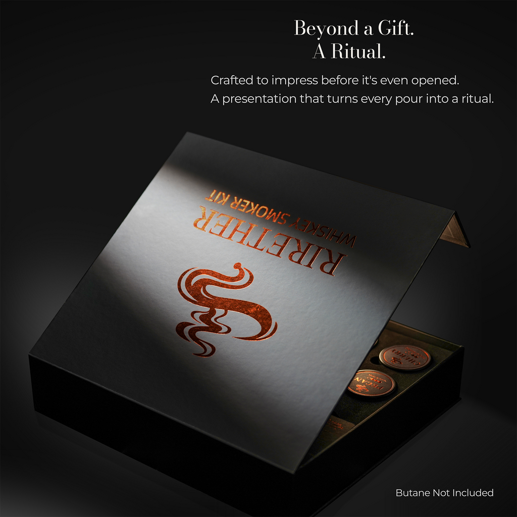 A premium presentation box for a 'Rigther' Whispy Smoker Kit, shown open to reveal copper coins inside. The box lid features a metallic silver finish with a copper-orange stylized flame logo and gold-toned text.