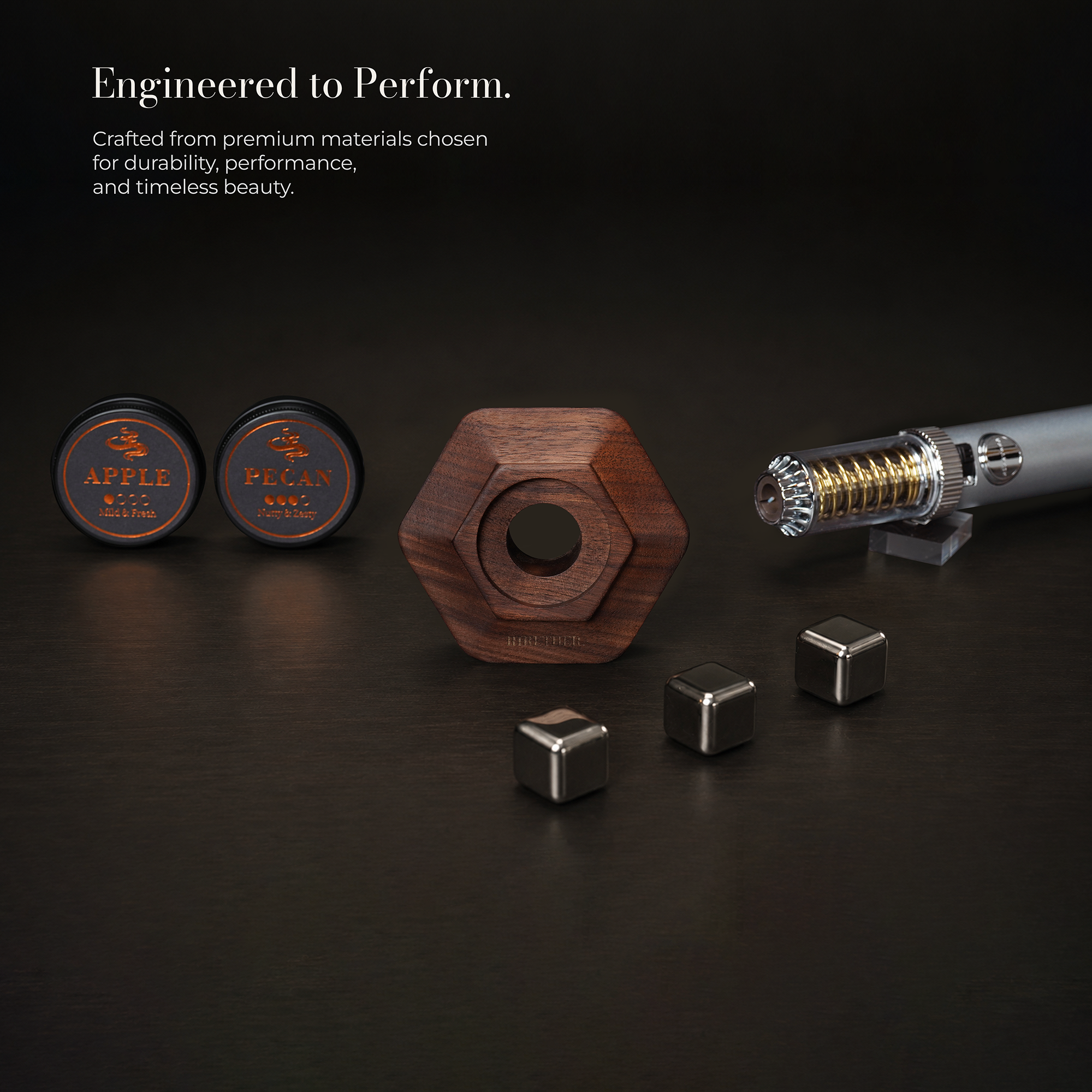 A set of Apple Pegan magnetic fitness pieces arranged on a dark surface, including two round black containers with gold Apple Pegan branding, a central hexagonal wooden weight, three silver metal cubes, and a metallic cylindrical component on a small stand. Text at the top reads 'Engineered to Perform.
