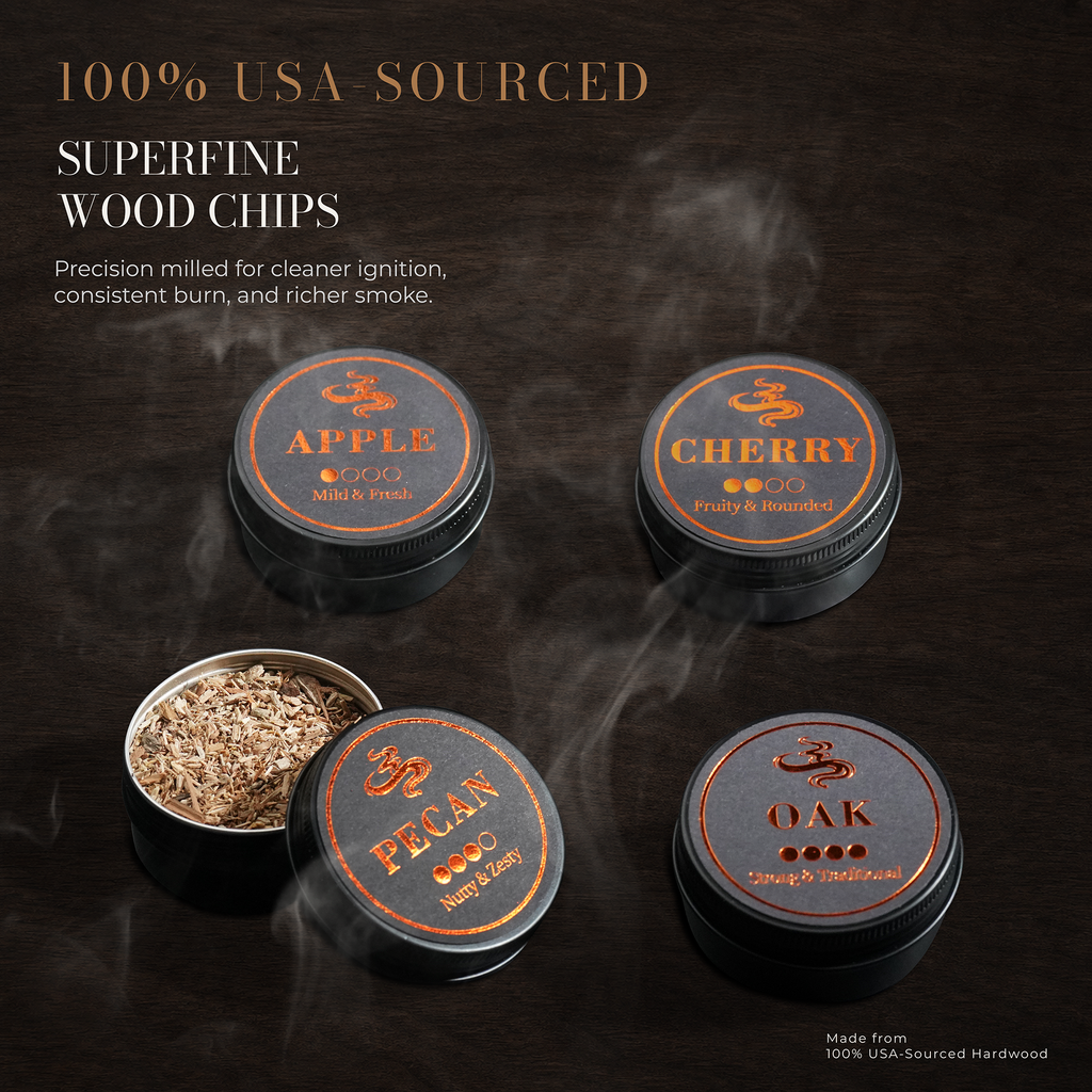 Four round metal tins of wood chips for smoking tobacco, shown on a dark wooden background with smoke effects. The lids are labeled Apple, Cherry, Pecan, and Oak, and one tin is open to show the wood chips inside.