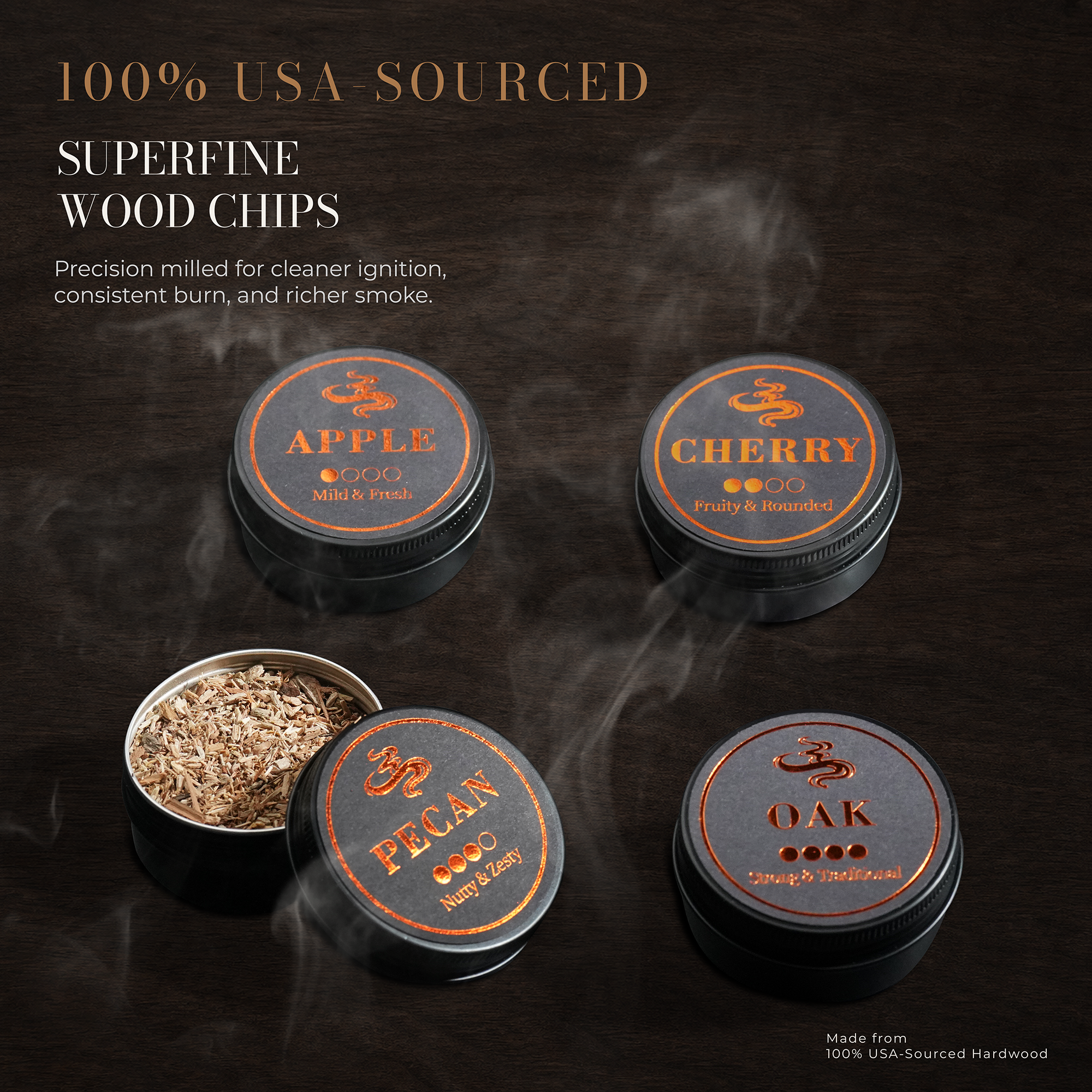 Four round metal tins of wood chips for smoking tobacco, shown on a dark wooden background with smoke effects. The lids are labeled Apple, Cherry, Pecan, and Oak, and one tin is open to show the wood chips inside.